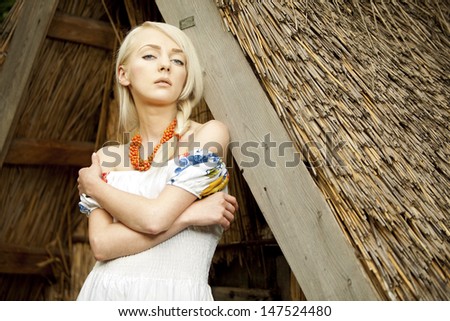 21 Mpix full-frame HD-capture. Professionally retouched. rural woman sitting near by old traditional Ukrainian  barn