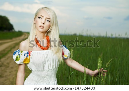 21 Mpix full-frame HD-capture. Professionally retouched. Rural woman standing on the road by the field