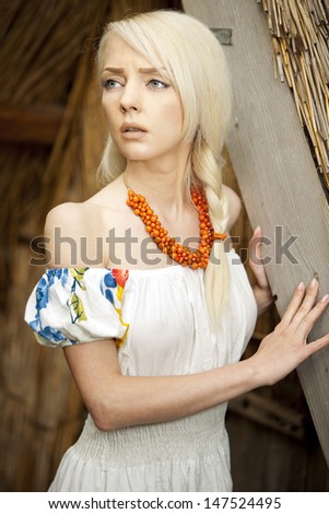21 Mpix full-frame HD-capture. Professionally retouched. rural woman sitting near by old traditional Ukrainian  barn