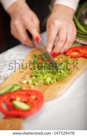 indoors shot. cutting vegetables. shallow depth of field