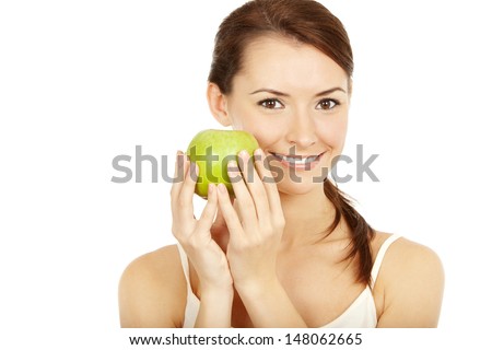 Professionaly retouched HD full-frame capture. Beautiful brunette holding green apple