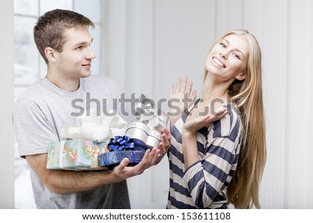 man giving presents to a young beautiful woman