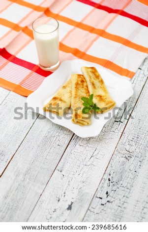 Tasty crepes on wooden table studio shot