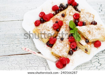 Tasty crepes on wooden table studio shot