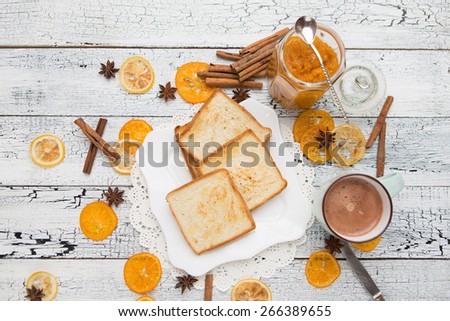 toast bread with mandarine jam on vintage wooden table