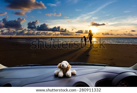 Look out the car window to see the sunset on the beach for use as a background.