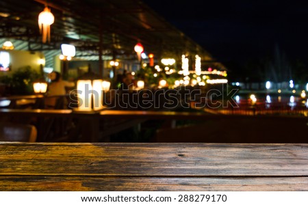Look out from the table, blurred  restaurant at night background scene.
