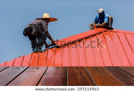 Look out from the table, workers are roofed with corrugated steel metal sheet. use for product presentation\
related Images.