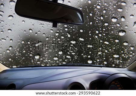 Look out the car window to see the raining on the road, use as a background.