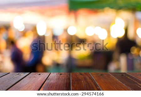 Look out from the table, people walking and shopping at street markets,use for background