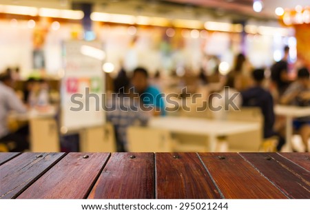 Blurred orange and green  food court in the mall background scene or use for product presentation related images.