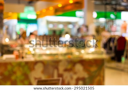 Blurred orange and green  food court in the mall background scene.