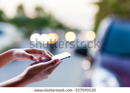 Woman using smart phone for help on the street .
