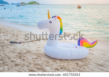 Unicorn swim tube on the beach\
Inflatable unicorn.\
Fantasy Swim Ring for Summer Pool Trip