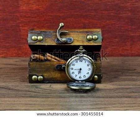 An antique box with a pocket watch.