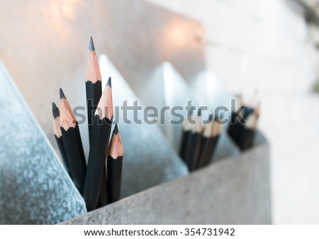 Black pencil in box. Black pencil. Pencil in box. Wooden pencil. Pencil set. Pencil concept. Black pencil collection. Sharpen pencil. Pencil and space. Black pencil at wall.
