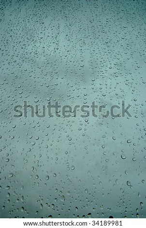 Window covered by rain drops (portrait orientation).