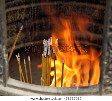 Burning incense sticks with dancing flames in Ngong Ping buddhist monastery (Hong Kong China)