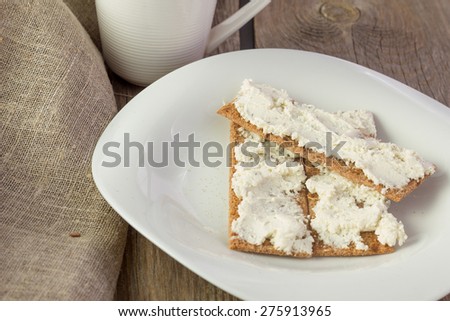 Crisp bread with cream cheese horizontal selective focus