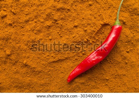Chili pepper pod on chili powder top view selective focus