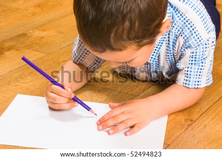 The boy draws pencils