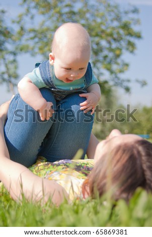 Mom makes the charge with your baby on the grass