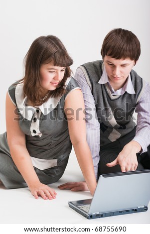 The man and the woman together work at the computer