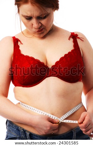stock photo The young beautiful big woman measures a waist by a flexible