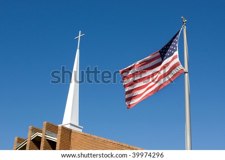 United States flag flies in front of a church steeple topped by a Christian cross.