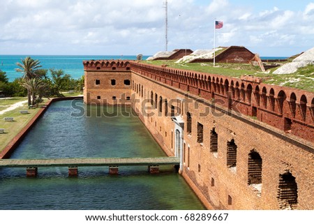 Wooden footpath crosses the moat and leads to the entrance of Fort Jefferson National Park in the Dry Tortugas.