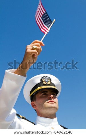 PENSACOLA, FL - SEPT. 11: US Navy Ensign Justin Nichols holds a US Flag on the ten year anniversary of 9/11 at a ceremony honoring those killed in the September 11, 2001 attack in Pensacola, FL