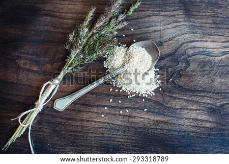 Fresh bouquet Herbs on the wooden table spoon seasame