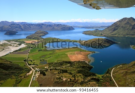 The lake Wakatipu near Queenstown under the wing of the airplane, South Island, New Zealand.