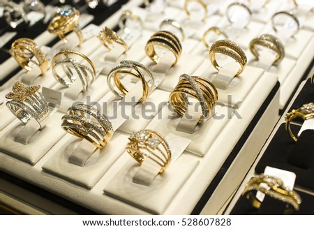 Golden rings with diamonds and other gemstones jewelry for women in the gold market