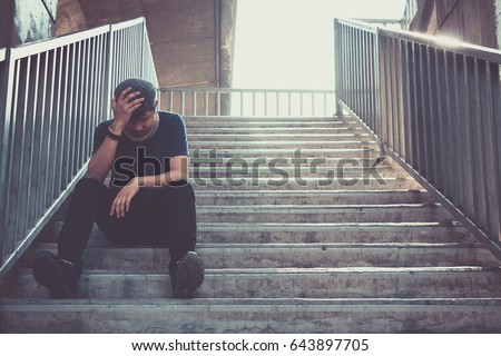 Depressed man sitting head in hands on the footbridge, Sad man, Cry, drama concept