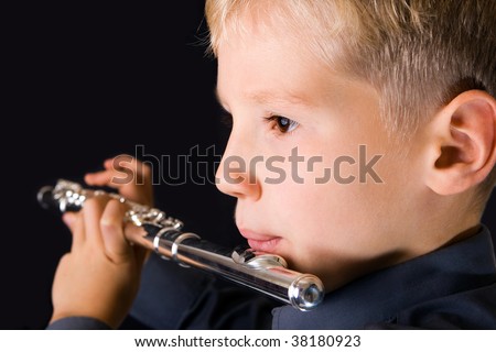 The ten years\' boy playing a flute