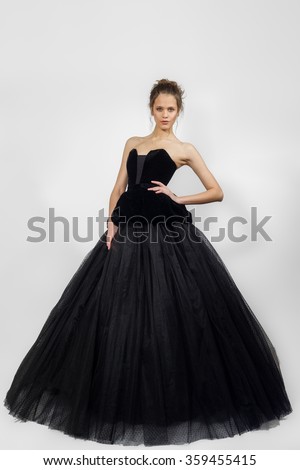 young lady posing in fashion long black dress