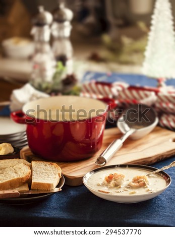 Christmas seafood chowder served with bread and Christmas crackers.