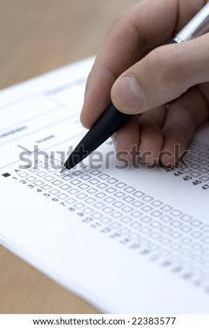 A closeup of a fill testing form with a pen