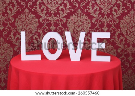 Inscription LOVE on red vintage wallpapers