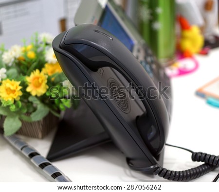 Black desktop phone in the office used to connect internal and external agencies.