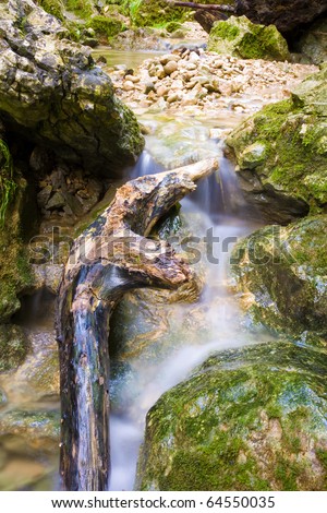 Water flows around stones in a long time exposure.