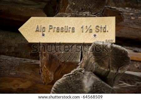old trail sign on a wooden hut