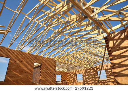 Structure of a wooden house under construction, in French.