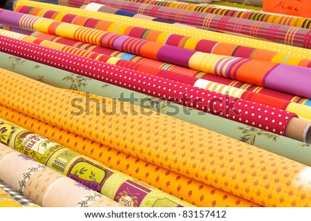 Rolls of colourful fabric at a market