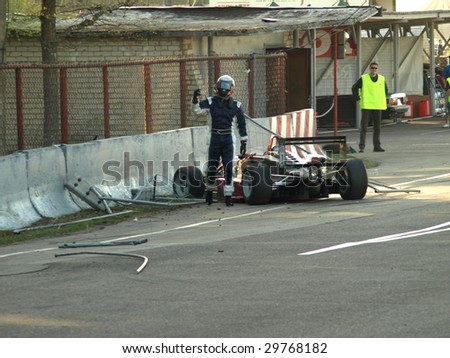 RIGA, LATIVA - MAY 2: Formula 3 racing car Crash during Baltic Touring Car Championship. Driver Jani Tammi right after the collision shows that he is OK. May 2, 2009 in Riga, Latvia