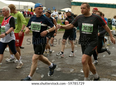RIGA, LATVIA - MAY 17: Riga Marathon 2009 - Long distance runners get to drink some water, May 17, 2009 in Riga, Latvia