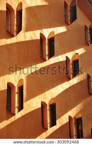 Side view of shaded windows of an old Stockholm apartment building with window shades half open