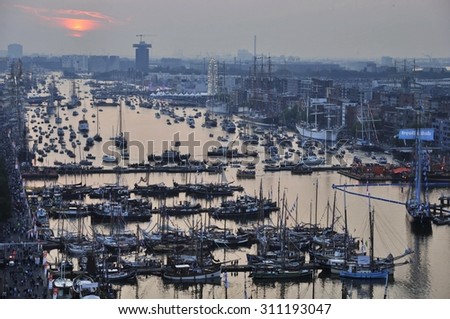 Port Amsterdam, Amsterdam, the Netherlands - August 19, 2015: Sunset view of the Ijhaven port on the 1st day of the SAIL (www.sail.nl), an international public nautical event held every 5 years.