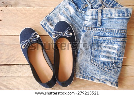 accessories jean style of young women, including a denim shorts, and dark blue shoes